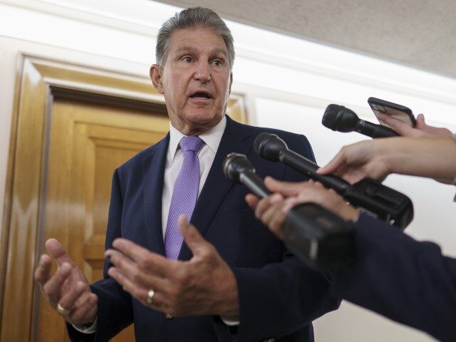 FILE - Sen. Joe Manchin, D-W.Va., talks with reporters on Capitol Hill in Washington, July 21, 2022. Senate Majority Leader Chuck Schumer and Manchin secreted themselves in a basement room at the Capitol. The two men had been wrestling for more than a year in long, failed rounds of start-and-stop …