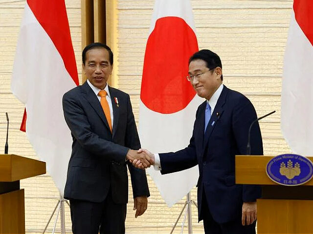 Joko Widodo, Indonesia's president, left, shakes hands with Fumio Kishida, Japan's prime m