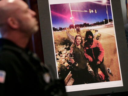 FILE - A law enforcement official stands next to a picture of Katelyn McClure and Johnny Bobbitt Jr., on display during a news conference in Mt. Holly, N.J., Thursday, Nov. 15, 2018. A New Jersey judge sentenced McClure to a term of one year and one day in prison, for …