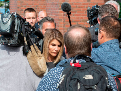 Actress Lori Loughlin (C) and husband Mossimo Giannulli (C rear) exit the Boston Federal Court house after a pre-trial hearing with Magistrate Judge Kelley at the John Joseph Moakley US Courthouse in Boston on August 27, 2019. - Loughlin and Giannulli are charged with conspiracy to commit mail and wire …