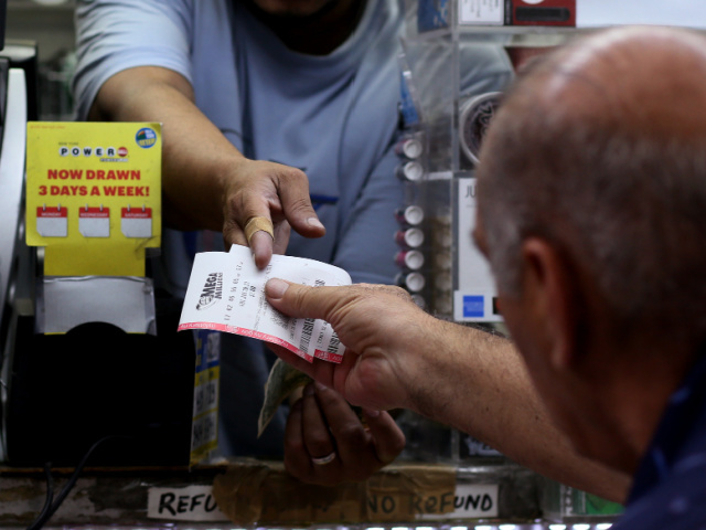 NEW YORK, NEW YORK - JULY 29: A man buys Mega Millions lottery tickets on July 29, 2022 in New York City. The Mega Millions jackpot has risen to an estimated $1.28 billion and would be the second-largest in the game's 20 year history. (Photo by John Smith/VIEWpress)