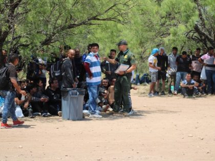 Migrants receive instructions from Border Patrol Agent