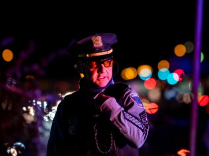 MINNEAPOLIS, MN - NOVEMBER 04: A member of the Minneapolis Police Department speaks into his radio as demonstrators march on to highway I-94 on November 4, 2020 in Minneapolis, Minnesota. The demonstration, scheduled as a critique of President Donald Trump's attempts to halt ballots from being counted in yesterday's election, …
