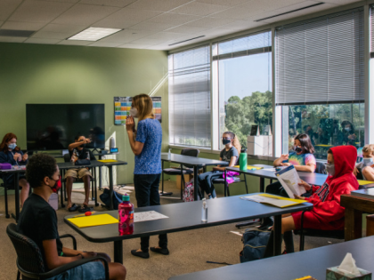HOUSTON, TEXAS - AUGUST 23: An instructor leads a classroom discussion at the Xavier Acade