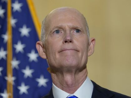 FILE - Sen. Rick Scott, R-Fla., talks with reporters on Capitol Hill in Washington, on Jan. 20, 2022. He was talking about President Joe Biden's first year as president. Two widely supported bills are encountering delays in the Senate. The House easily approved the measures last week with broad bipartisan …