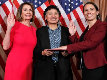 House Speaker Nancy Pelosi of Calif., left, poses during a ceremonial swearing-in with Rep. Sharice Davids, D-Kan., second from right, on Capitol Hill, Thursday, Jan. 3, 2019 in Washington during the opening session of the 116th Congress.. (AP Photo/Alex Brandon)