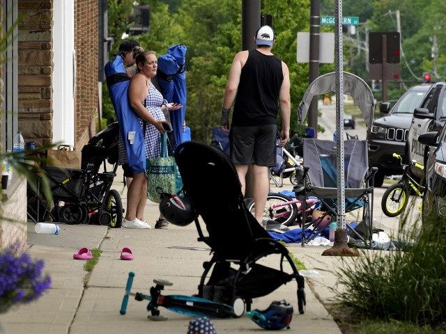 People check their belongings after a mass shooting at the Highland Park Fourth of July parade in downtown Highland Park, Illinois, a suburb of Chicago, on Monday, July 4, 2022. (Nam Y. Huh/AP)