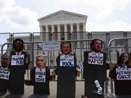 The Photographs of the the Supreme Court justices are left at the fence outside the Suprem