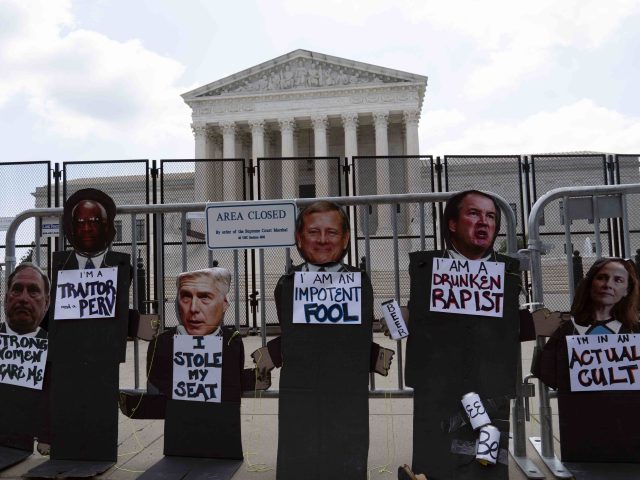The Photographs of the the Supreme Court justices are left at the fence outside the Supreme Court in Washington, Friday, June 24, 2022. The Supreme Court has ended constitutional protections for abortion that had been in place nearly 50 years, a decision by its conservative majority to overturn the court's …