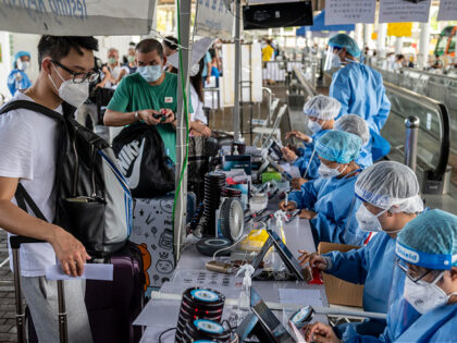 Travellers registering before a Covid-19 PCR test at Shenzhen Bay Port on July 15, 2022 in Hong Kong, China. Travellers are required to reserve a PCR test at the control point through an online booking system. They must test negative for Covid-19 before they are allowed to cross the border. …
