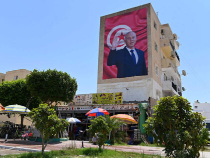 A billboard depicting Tunisia's Kais Saied hangs on the side of a building in the east-central city of Kairouan, on July 26, 2022. - Saied said that Tunisia was moving "from despair to hope" after a referendum almost certain to approve a new constitution that concentrates nearly all powers in …