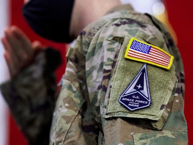 FILE - A solider wears a U.S. Space Force uniform during a ceremony for U.S. Air Force airmen transitioning to U.S. Space Force guardian designations at Travis Air Force Base, Calif., Feb. 12, 2021. More than half of Air Force and Space Force personnel who responded to a survey said …