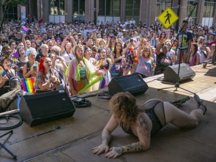 People watch a drag show during celebrations for Pride month on June 25, 2022, in Raleigh,