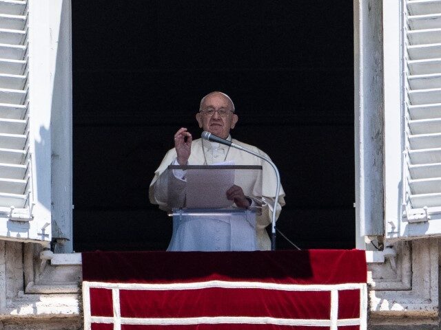Pope Francis addresses the crowd from the window of the apostolic palace overlooking Saint Peter's Square during his Sunday Angelus prayer on July 10, 2022, at the Vatican. (TIZIANA FABI/AFP via Getty Images)