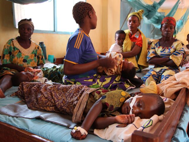 A child suffering from malaria lies on a bed at the hospital of Nyarugusu, in north west o