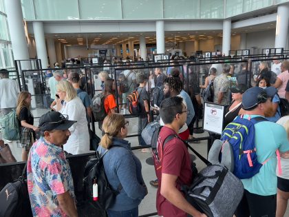 Passengers stand in line to go through security at Charlotte Douglas International Airport (CLT) in Charlotte, North Carolina, on July 2, 2022. - US airlines are bracing customers for what will probably be a bumpy Fourth of July holiday weekend as the industry struggles to manage a surge in travel …