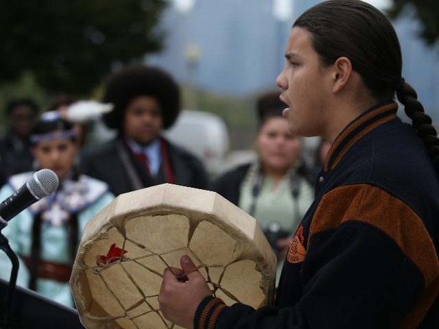Adrien Pochel of Cree & Lakota tribe drums and sings outside the Field Museum during a land acknowledgement ceremony in recognition of the fact that the museum sits on traditional Native land on Friday, Oct. 26, 2018. (Antonio Perez/ Chicago Tribune/TNS)