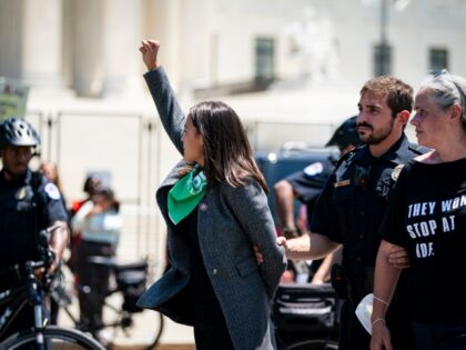 Representative Alexandria Ocasio-Cortez, a Democrat from New York, is arrested outside the US Supreme Court during a protest of the court overturning Roe v. Wade in Washington, D.C., US, on Tuesday, July 19, 2022. Photographer: Al Drago/Bloomberg via Getty Images