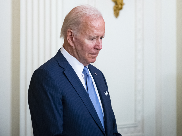 US President Joe Biden bows his head during a prayer during a Medal of Honor ceremony in t