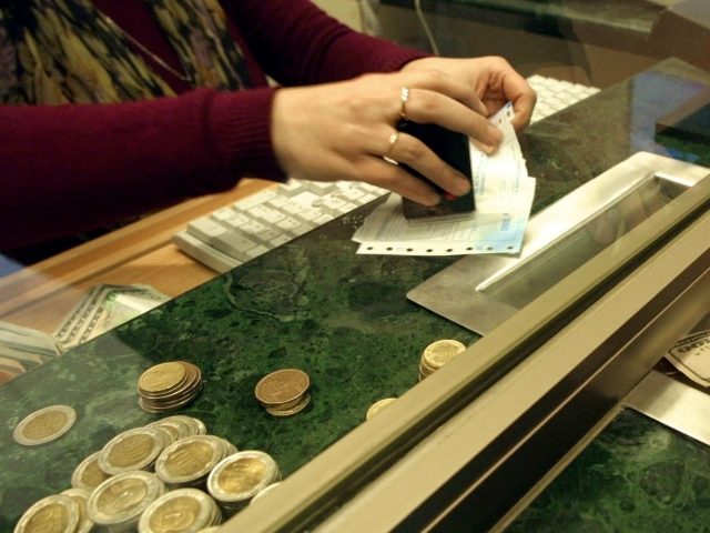 SANTIAGO, CHILE: A civilian buys dollar at a currency exchange house in Santiago, Chile, 2