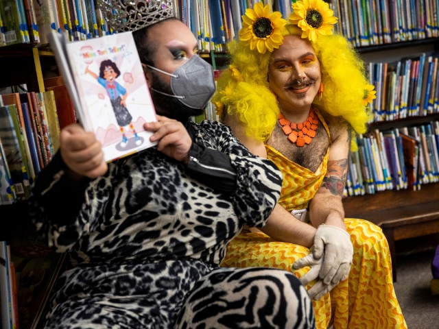 Chelsea, MA - June 25: Drag queens Just JP, left, and Sham Payne read stories to children during a Drag Story Hour at Chelsea Public Library in Chelsea, MA on June 25, 2022. In the past few months, many drag queens have experienced increased fear and threats. (Photo by Erin Clark/The Boston Globe via Getty Images)