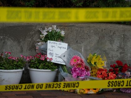 Flowers are left for victims of the 4th of July mass shooting in downtown Highland Park, I