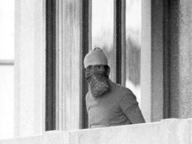 A masked Arab terrorist shows himself on the balcony of the Israeli team's accomodation in