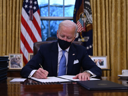 President Joe Biden sits in the Oval Office as he signs a series of executive orders at the White House in Washington, DC, after being sworn in as president on January 20, 2021. (Jim Watson/AFP via Getty Images)