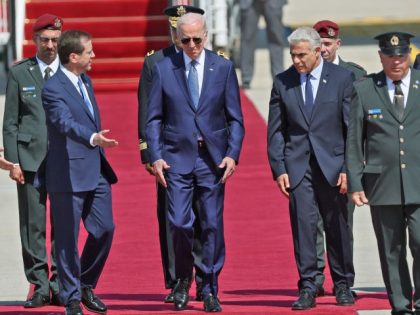 Israel's President Isaac Herzog (L) and caretaker Prime Minister Yair Lapid (R) welcome US President Joe Biden (C) upon arrival at Ben Gurion Airport in Lod near Tel Aviv, on July 13, 2022. (Photo by JACK GUEZ / AFP) (Photo by JACK GUEZ/AFP via Getty Images)