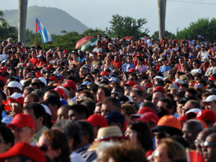 People attend a ceremony to celebrate the 57th anniversary of the Moncada Barracks attack which marked the beginning of the Cuban Revolution, on July 26, 2010 at Che Guevara Revolution Square in the legendary city of Santa Clara, 280 km east of Havana. AFP PHOTO/Adalberto ROQUE (Photo credit should read …