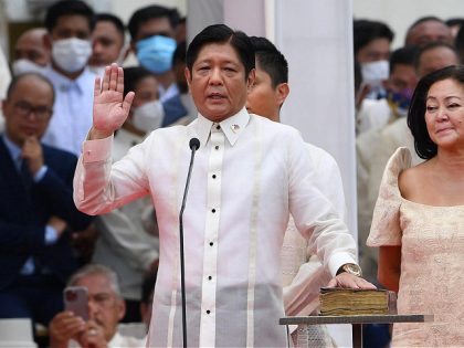 TOPSHOT - New Philippine President Ferdinand Marcos Jr. (L) takes the oath as president of the Philippines as his wife Louise (R) looks on, during the inauguration ceremony at the National Museum in Manila on June 30, 2022. (Photo by Ted ALJIBE / AFP) (Photo by TED ALJIBE/AFP via Getty …