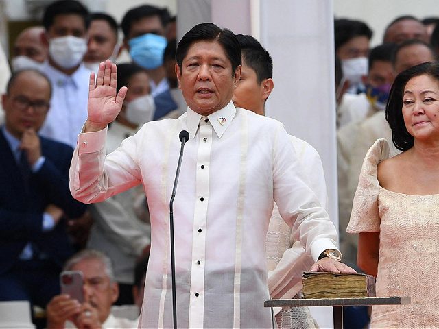 TOPSHOT - New Philippine President Ferdinand Marcos Jr. (L) takes the oath as president of