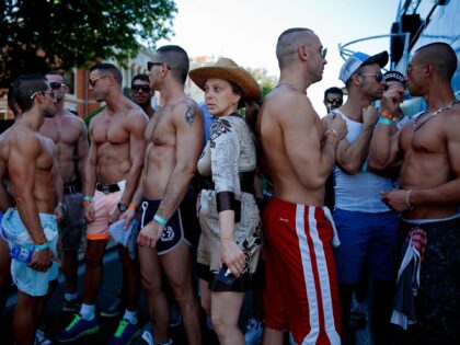 MADRID, SPAIN - JULY 06: A woman tries to pass between gay men during the Madrid Gay Pride Parade 2013 on July 6, 2013 in Madrid, Spain. According to a new Pew Research Center survey about homosexual acceptance around the world, Spain tops gay-friendly countries with an 88 percent acceptance …