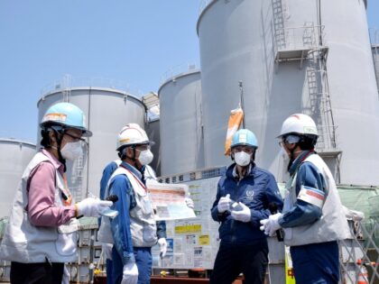 Director General of the International Atomic Energy Agency (IAEA) Rafael Grossi (2nd-R) stands in front of the storage tanks for radioactive water as he visits the Tokyo Electric Power Company Holdings (TEPCO) Fukushima Daiichi nuclear power plant in Okuma, Fukushima prefecture on May 19, 2022. - Japan OUT (Photo by …