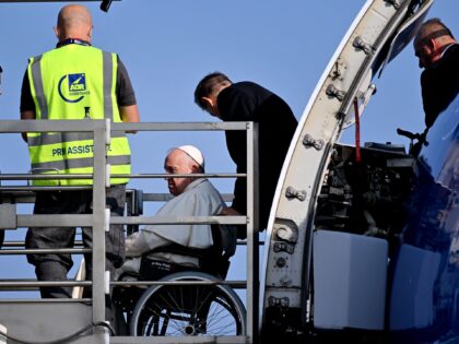 Pope Francis boards his plane from a lift designed for the boarding and off boarding of re