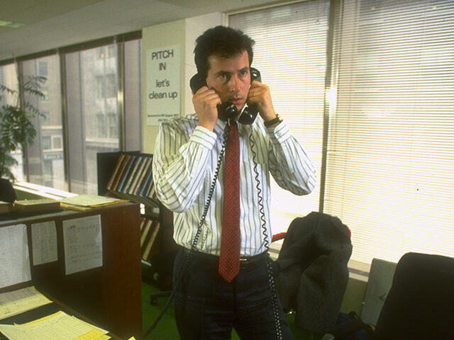 Broker using two telephones simultaneously at Manufacturers Hanover Trust. (Photo by Bill
