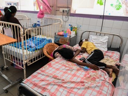 In this picture taken on April 21, 2022, a child lies in a bed while his mother sits beside in Lady Ridgeway Hospital for Children in Colombo. - Sri Lanka used to import around 85 percent of its pharmaceutical supplies but is suffering its worst economic crisis since 1948. (Photo …