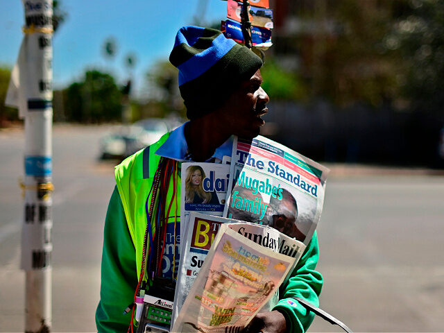 A street vendor sells local newspapers in the streets of Harare carrying a picture of late former president Robert Mugabe on September 8, 2019. - Mugabe, a guerilla leader who swept to power after Zimbabwe's independence from Britain and went on to rule for 37 years, died on September 6, …
