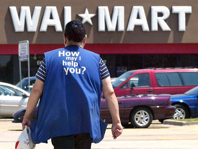 A Wal-Mart employee walks through a parking lot as she returns to work at a Wal-Mart store