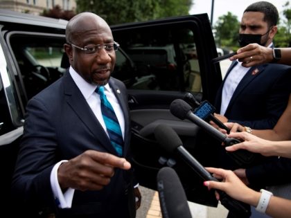 Sen. Raphael Warnock (D-GA) talks with reporters after speaking at a rally, hosted by the Declaration for American Democracy coalition, calling on the Senate to pass the For the People Act, outside the Supreme Court in Washington on Wednesday, June 9, 2021. (Photo by Caroline Brehman/CQ-Roll Call, Inc via Getty …