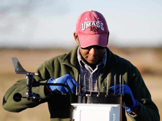 ENGELHARD, NC - January 22: Assistant professor and ecologist, Alex Manda sets up a weather station as his graduate students from East Carolina University study the ground water on a farm field outside the coastal town of Engelhard, NC, Tuesday, January 22, 2019. The coastal farms surrounding Engelhard and Middletown, …