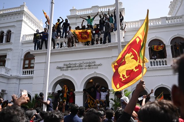 Some of the civilians sang or waved the Sri Lankan flag, with its motif of a golden lion b