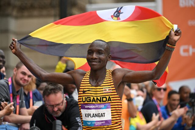 Uganda's Victor Kiplangat celebrates winning marathon gold at the Commonwealth Games in Bi