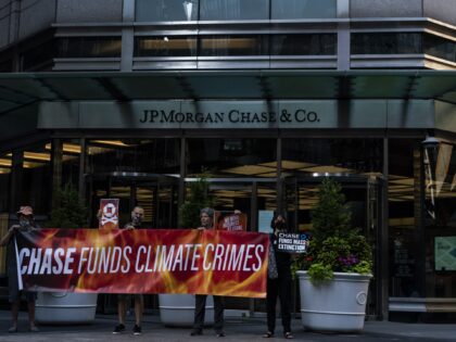 Climate activists protest outside of a JPMorgan Chase & Co. Bank branch during a heatwave