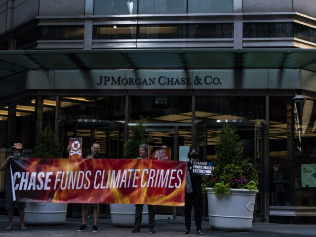 Climate activists protest outside of a JPMorgan Chase & Co. Bank branch during a heatwave in New York, U.S., on Friday, Aug. 13, 2021. A heat wave smothering the U.S. East Coast is expected to peak on Friday, setting new records in New York before a welcome cooling front arrives. …