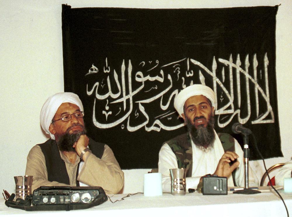 FILE - In this 1998 file photo made available Friday, March 19, 2004, Ayman al-Zawahri, left, listens during a news conference with Osama bin Laden in Khost, Afghanistan.  A US airstrike killed al Qaeda leader Ayman al-Zawahri in Afghanistan, according to a person familiar with the matter.  President Joe Biden will address the operation on Monday night, August 1, 2022, from the White House.  (AP Photo/Mazhar Ali Khan, File)