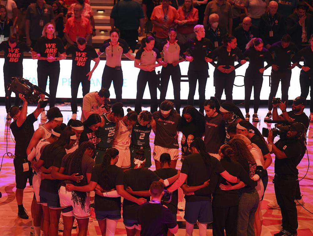 Connecticut Sun and Phoenix Mercury players tie their arms for 42 seconds in honor of Phoenix Mercury center Britney Grenier before the WNBA basketball game Thursday, August 4, 2022 in Uncasville, Connecticut.  He was sentenced to nine years in prison.  (Sarah Gordon/Today via The Associated Press)