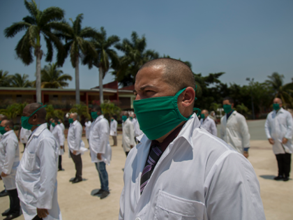 Cuban doctors form up during a farewell ceremony as they get ready to leave for Italy to h