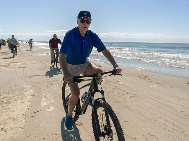President Joe Biden rides a bicycle along the beach at Kiawah Island, S.C., Sunday, Aug. 1