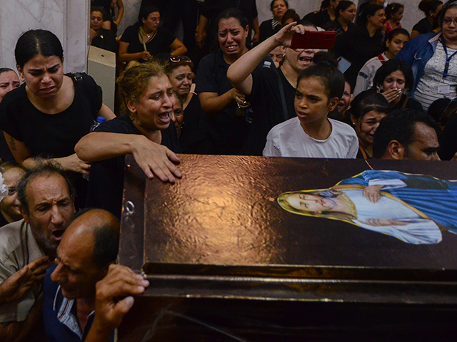 Mourners attend a memorial service for victims of a fire at a church in Greater Cairo that